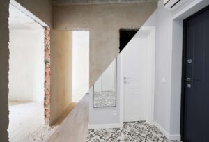 Modern apartment with doorways before and after refurbishment. Comparison of old flat and new place with white walls and modern interior design. Concept of home renovation.