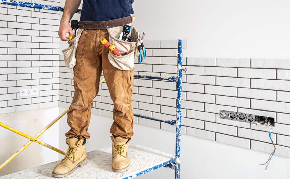 un professionnel dans une salle bain blanche pour des travaux, rénovation salle de bain toulouse